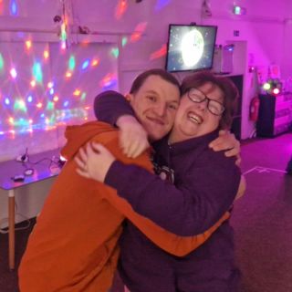 Man and woman hugging at a Gateway Disco