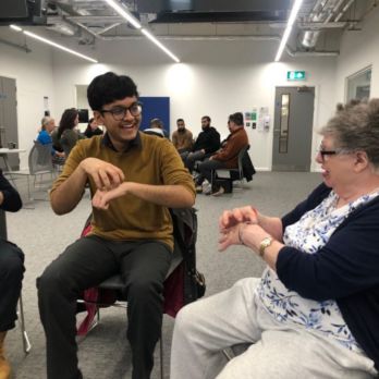 Student doctor using sign language with a lady who has a learning disability
