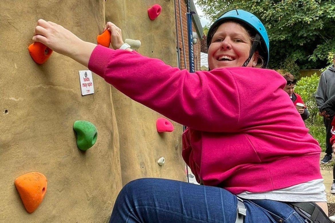 Lady smiling on the climbing wall