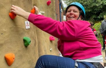 Lady smiling on the climbing wall