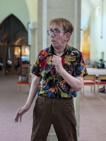 Paul striking a pose in front of a pillar