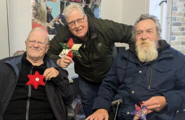 Rogan, Kevin and Ted holding their festive stars