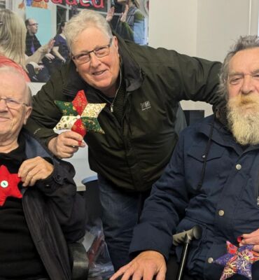 Rogan, Kevin and Ted holding their festive stars