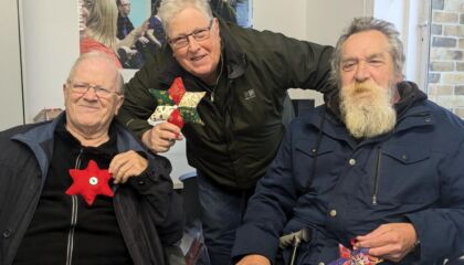 Rogan, Kevin and Ted holding their festive stars