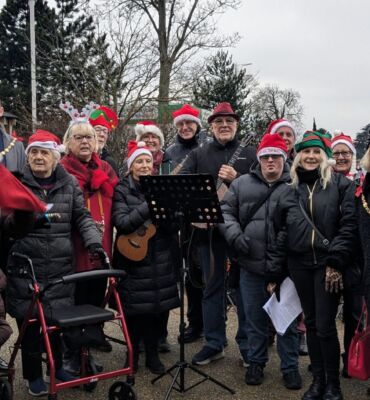 Group of festive carol singers standing outside