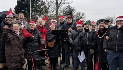 Group of festive carol singers standing outside